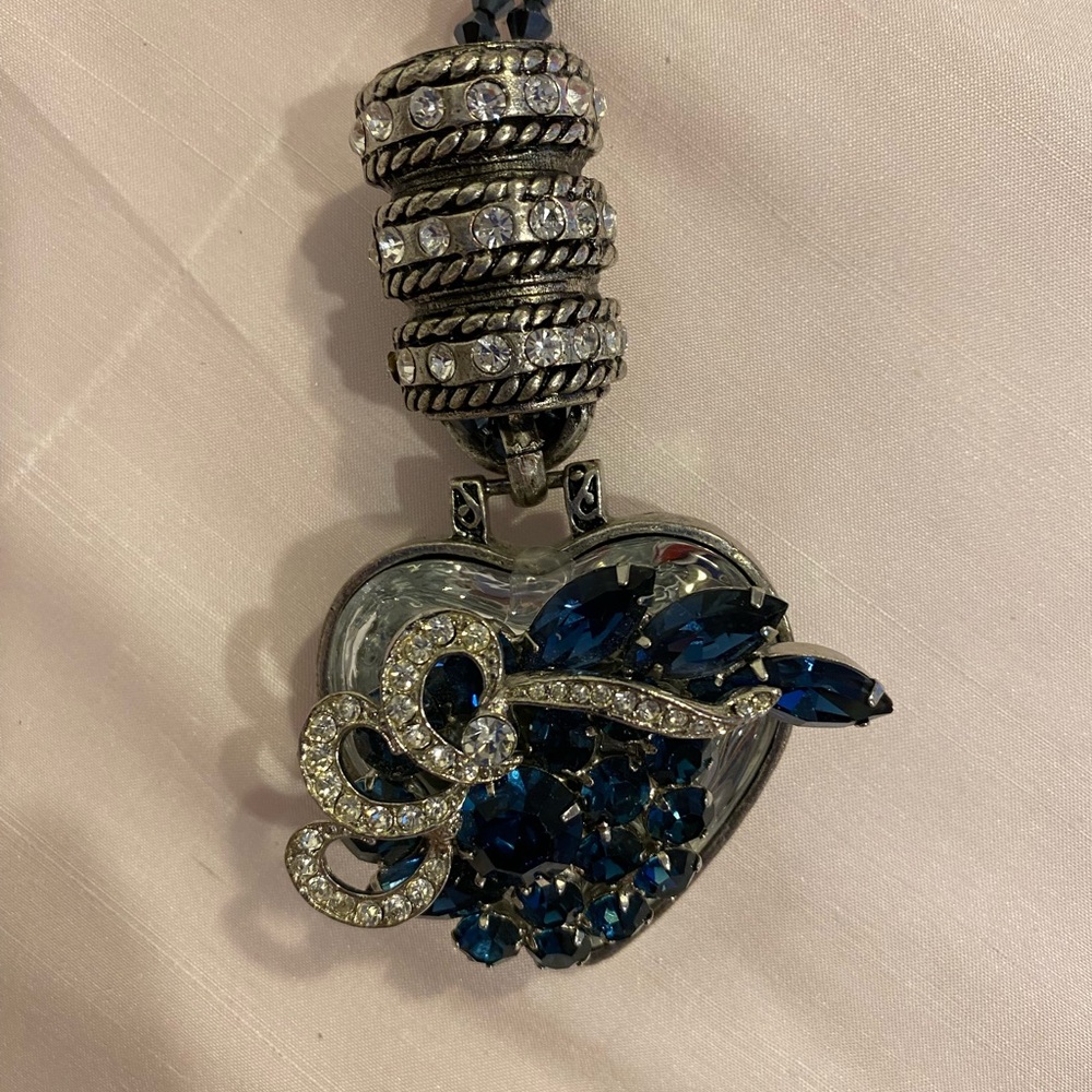 32” handcrafted necklace.  Vintage brooch on glass heart.  Crystal beads.